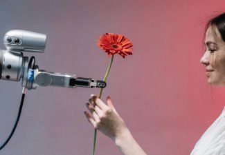 Robot and human sharing a flower