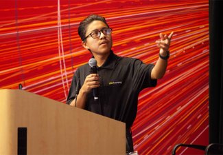 Man presenting at a podium at a previous USC Annenberg event