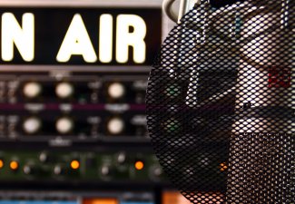 Image of a radio microphone and an "on air" sign