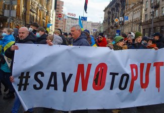 March of Ukrainian protesters against Russian aggression with political banner "Say No to Putin".