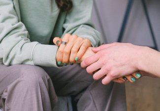 Photo of a person holding another person's hand