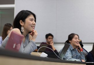 Photo of students in a classroom smiling