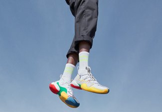 Person wearing colorful shoes and jumping against a blue sky