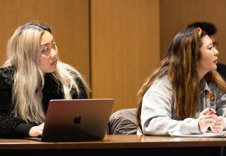 Two people listening to a presentation