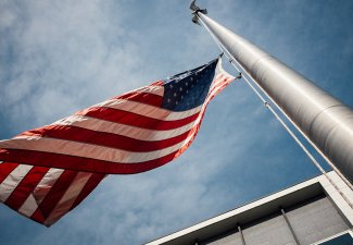 Photo of American Flag flying on a pole