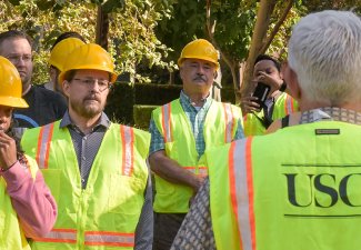 Group at USC wearing safety jackets and hard hats