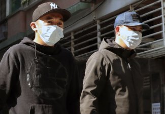 Photo of two people wearing masks