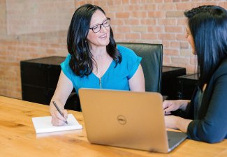 Photo of two women conversating