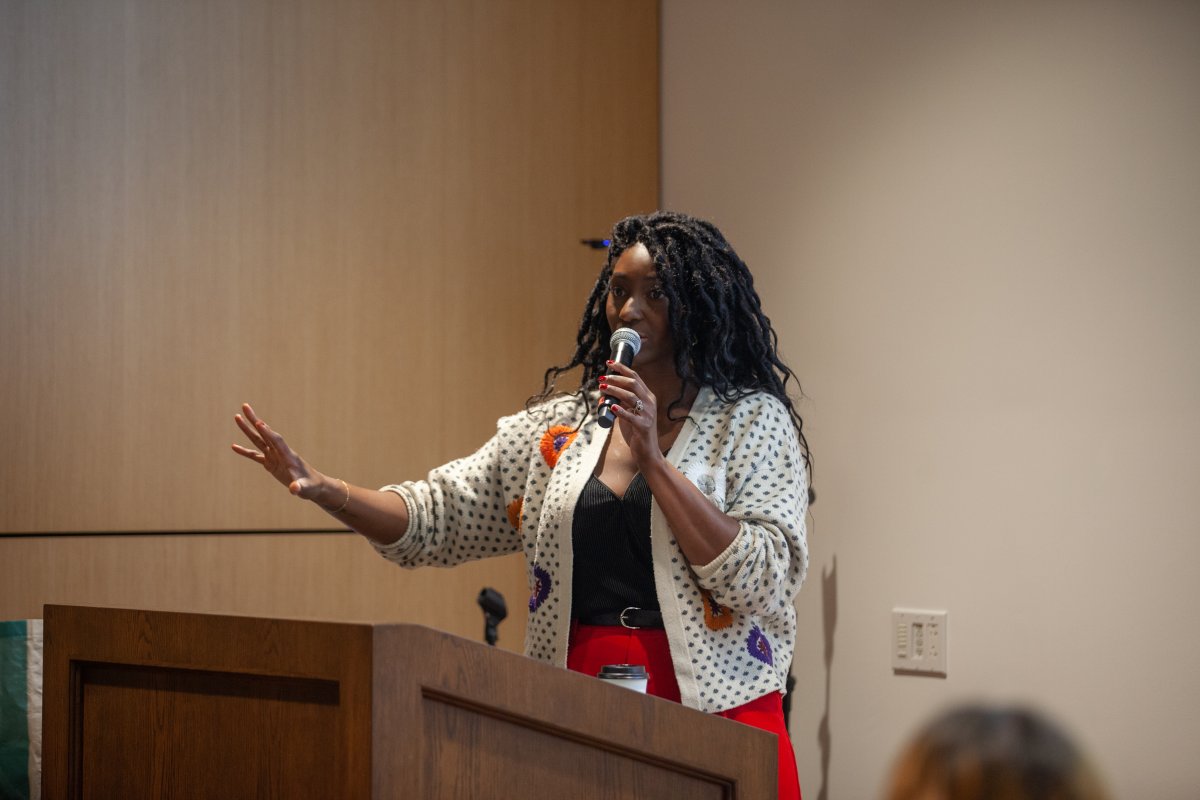 black woman speaks in microphone