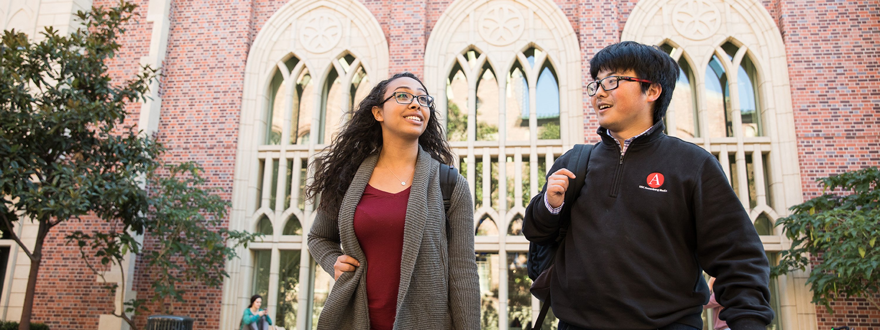 Photo of two USC Annenberg students walking outside of USC Annenberg
