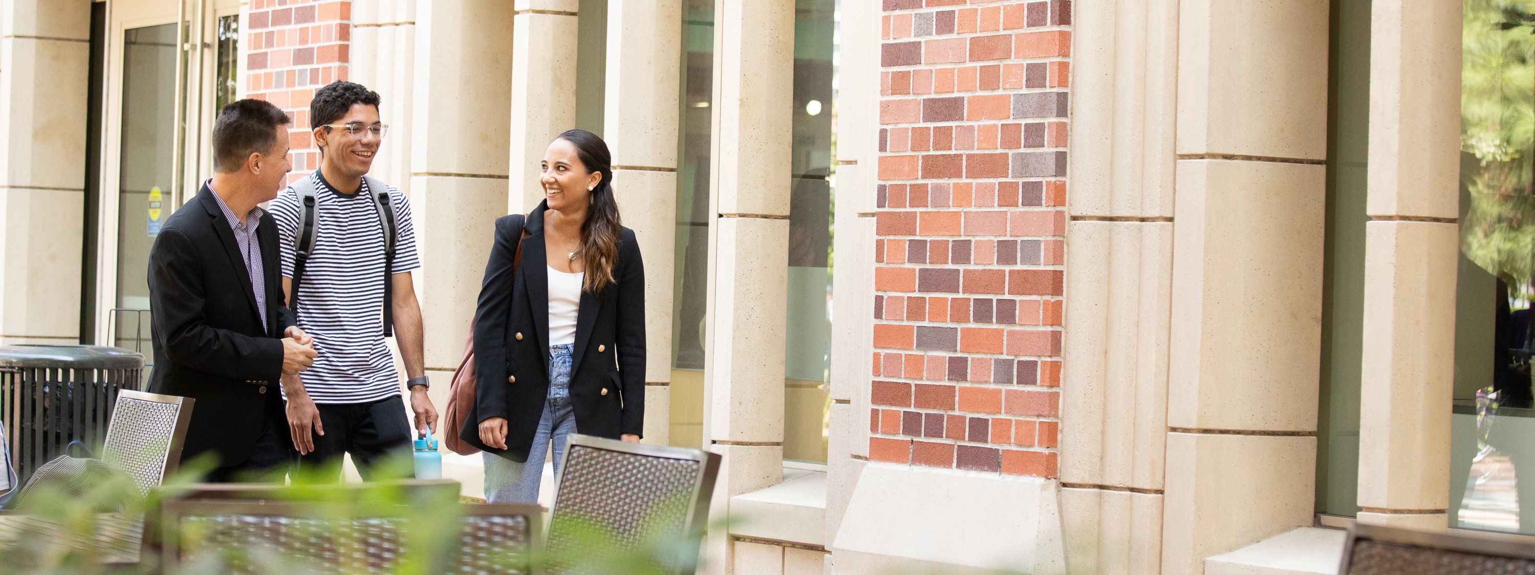 Photo of three people walking on USC's campus