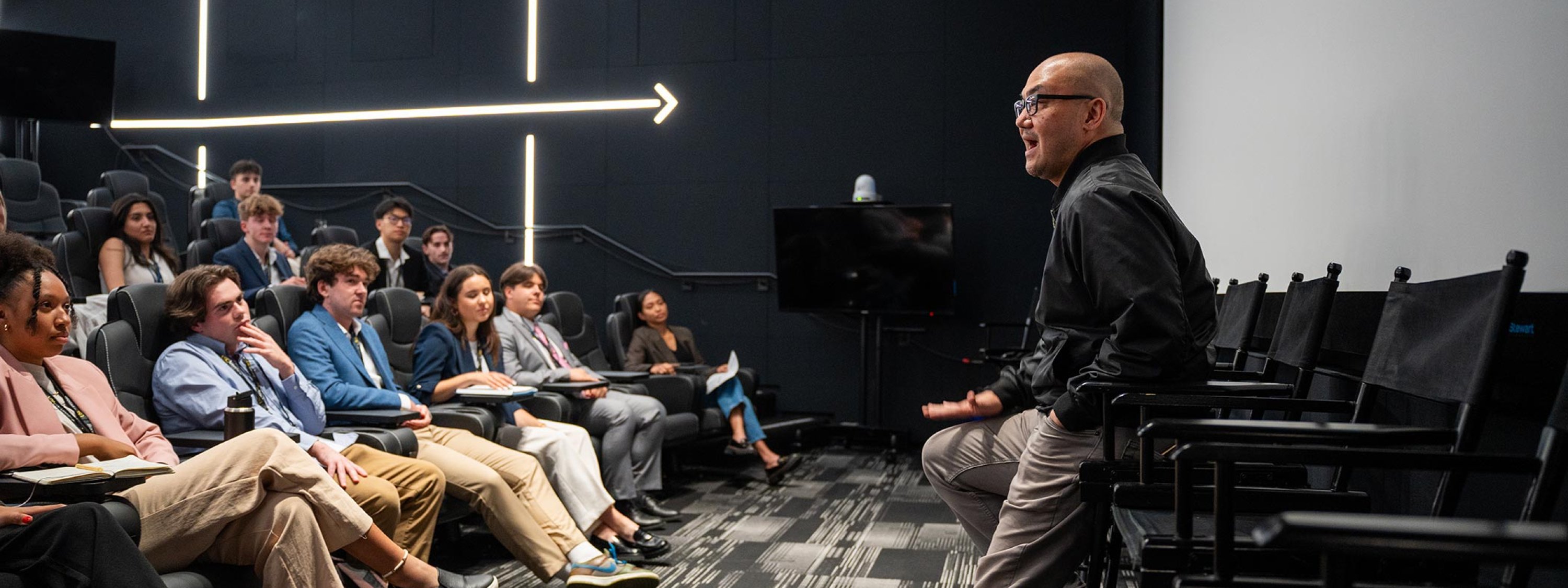 A man speaking to a group of students