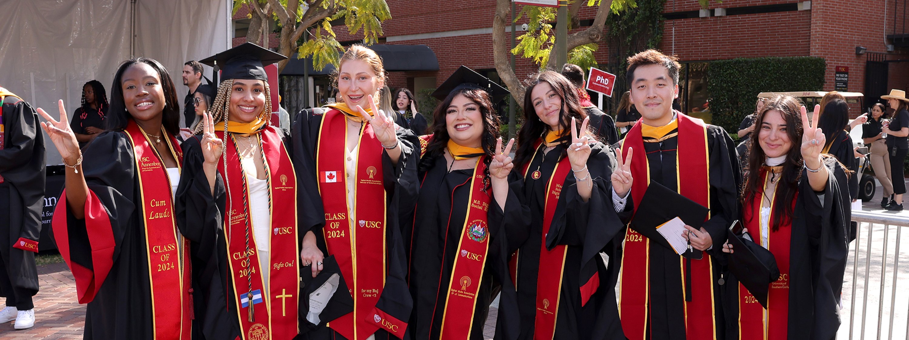 Students in commencement regalia gather outside USC Annenberg's 2024 Commencement Ceremony. 