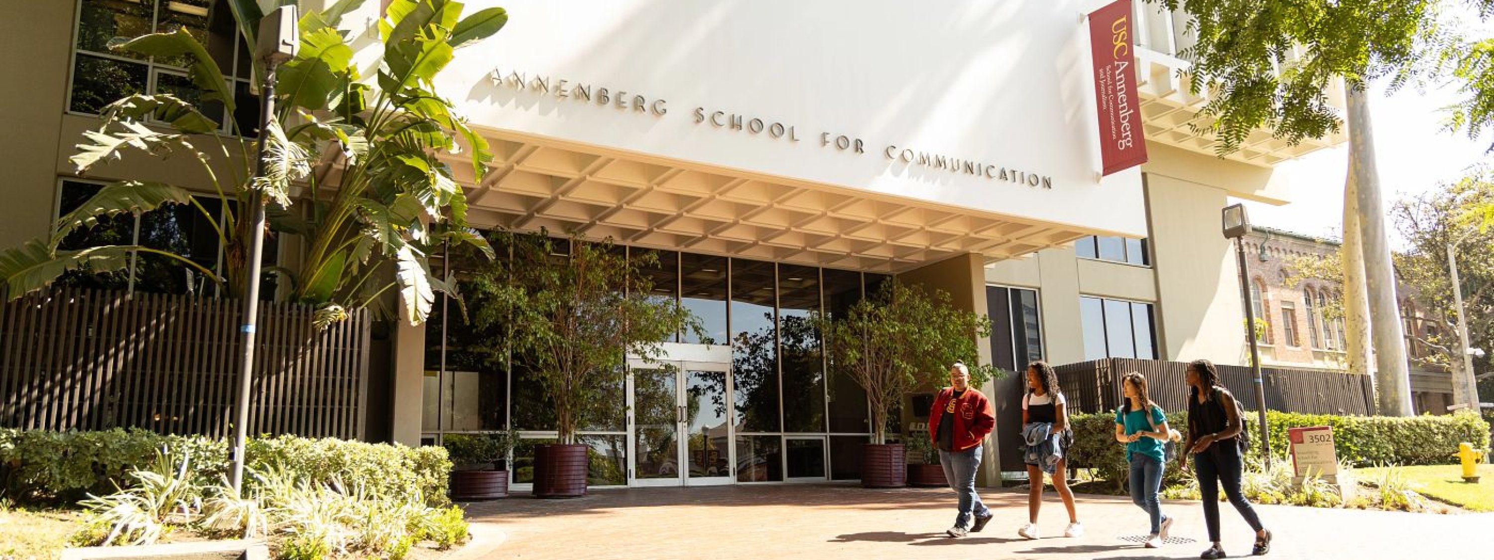 Students walking outside ASC on a sunny day.