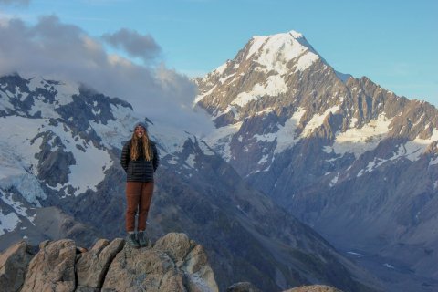 women stands on top of mountain at Mount Cook National Park