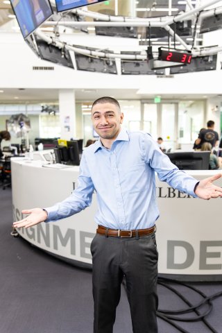 Ray Troncoso smiles and shrugs in front of the USC Annenberg media center 