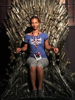 Doctoral student joan miller sits on the Iron Throne at Comic-Con International.