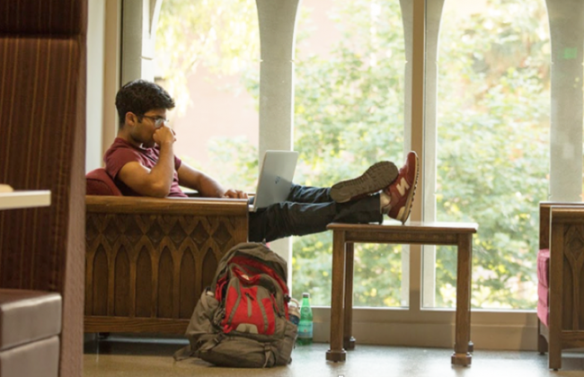 Photo of a person sitting with their legs on a table