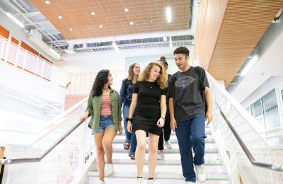Students walking down stairs in Wallis Annenberg Hall.