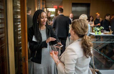 Photo of two people speaking at a reception