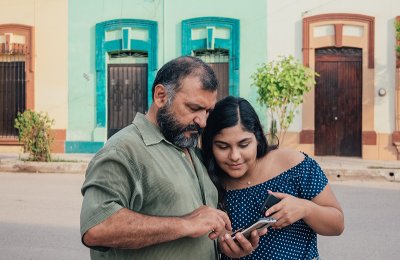 Photo of two people looking at a smartphone