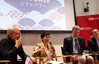 Woman speaking at a public diplomacy event on soft power.
