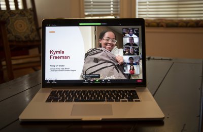 Photo of a laptop with Kymina Freeman on the screen