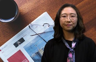 Su Jung Kim and a piece of paper, glasses and coffee mug. 