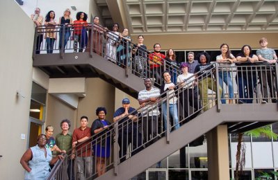 Photo of people standing on the outside stairway of the ASC building