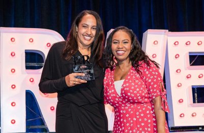 Associate Director of the Public Relations and Advertising (BA) program Melanie Cherry (left) accepts USC Annenberg's award for Outstanding Education Program from Broadway and Wicked star Brittney Johnson, who emceed the 25th annual PRWeek Awards. 