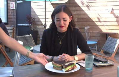 Photo of a person being served a sandwich