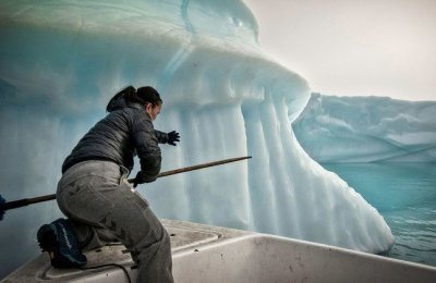 A person near an ice berg. 