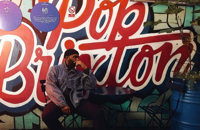 Photo of person sitting in front of Pop Brixton sign