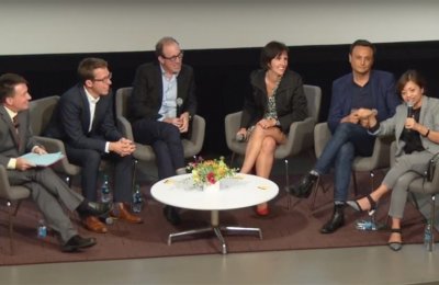 Photo of people sitting next to eachother in a panel