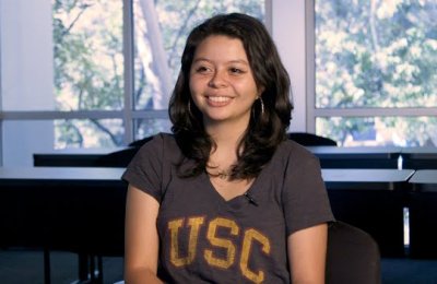 Katherine Contreras Hernandez smiling at the camera wearing a USC t-shirt.