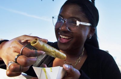 Photo of a person holding a taquito