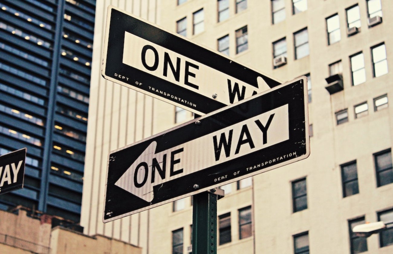 Photo of one way signs on a street