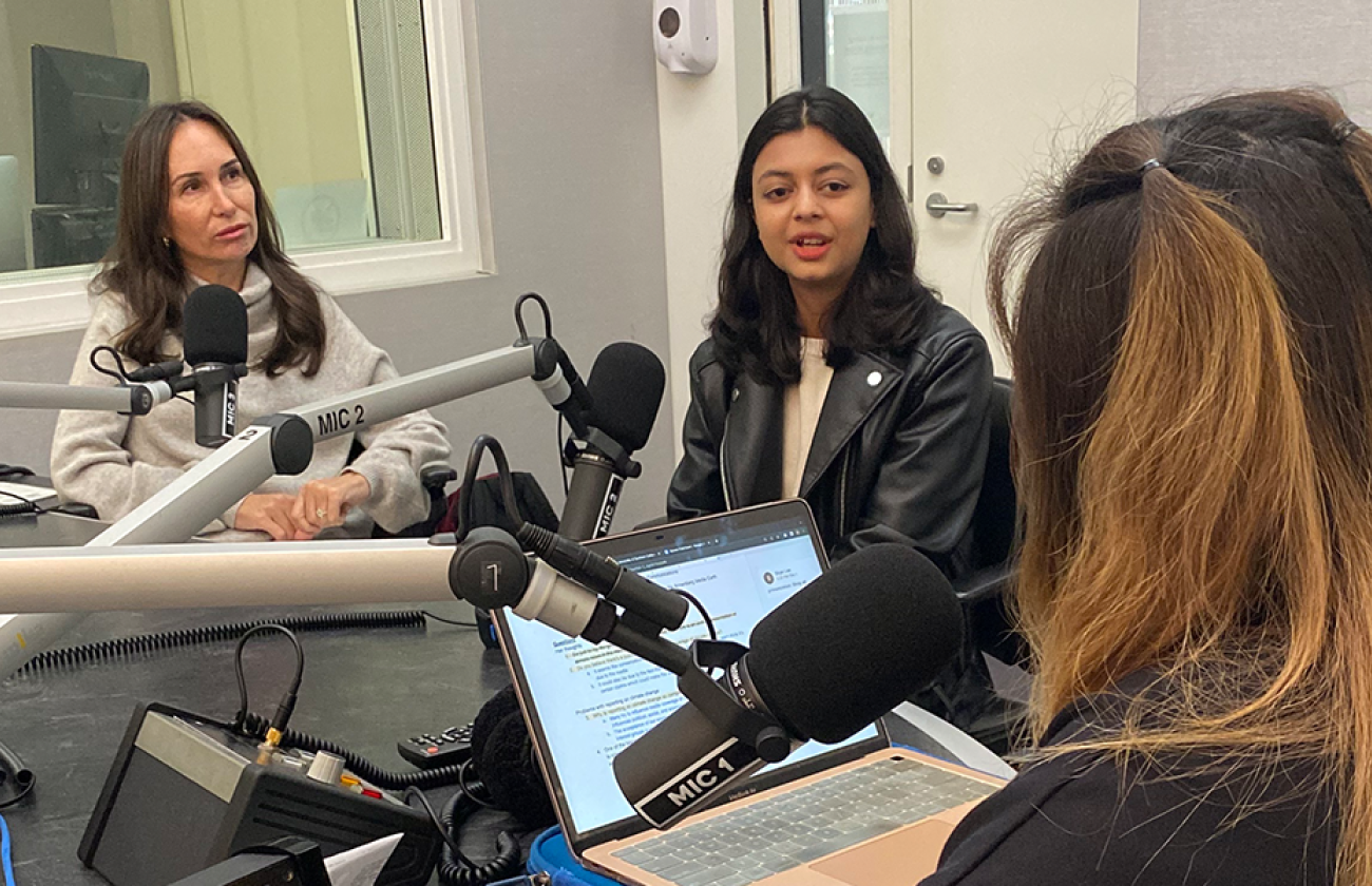 Three women in discussion in podcast studio