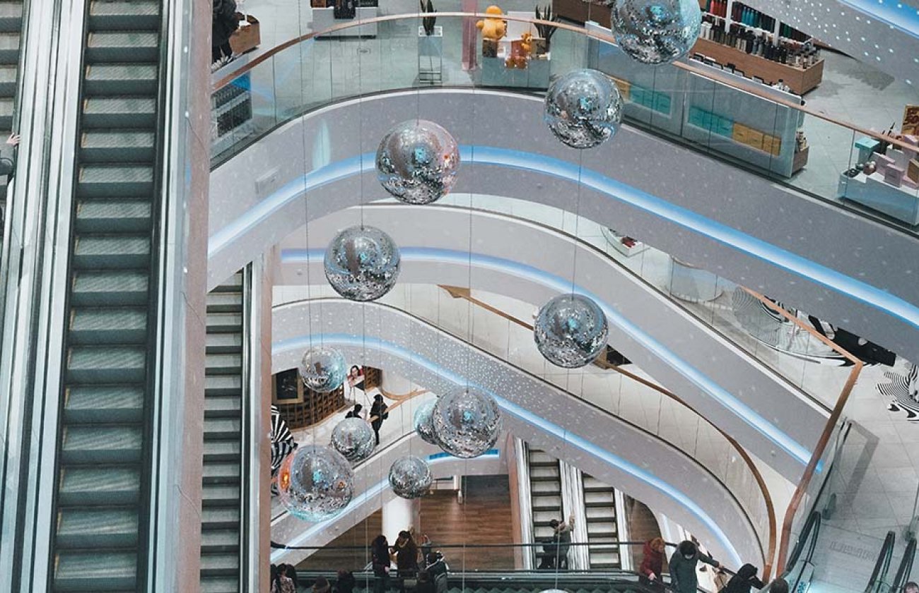 Photo of a retail shopping center displaying an escalator and many levels