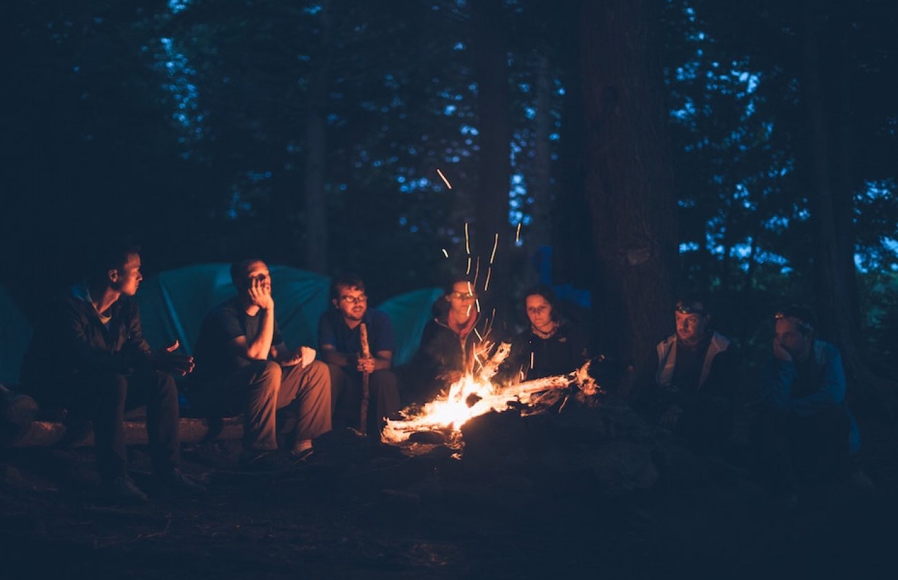 Photo of people around a campfire
