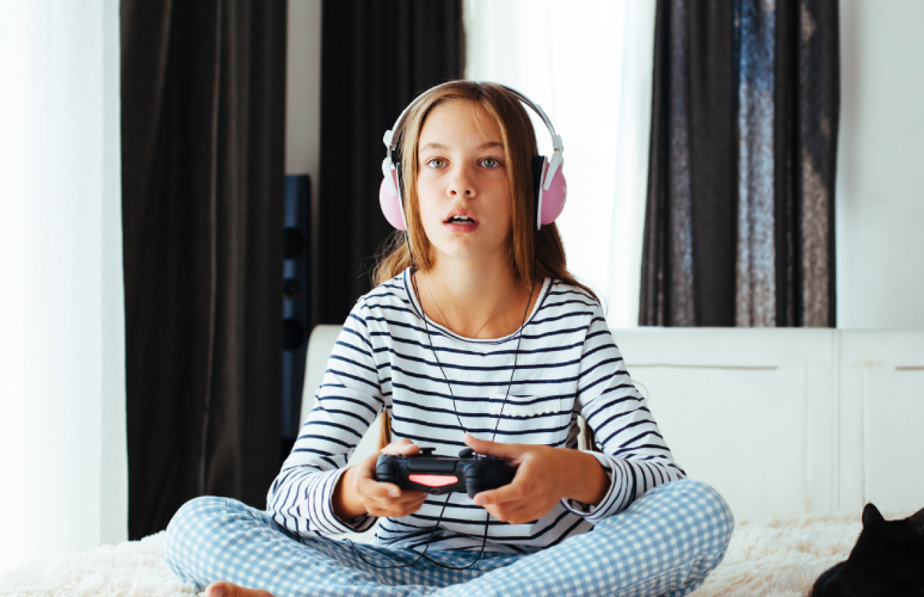 Photo of a young girl playing a video game