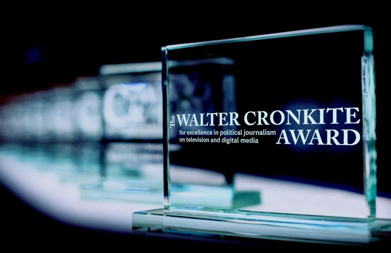 Glass awards extend back into a black background.