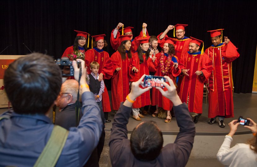 Ph.D. graduates pose for photographs for their family and friends after receiving their degrees on May 14, 2105 at the USC Annenberg School for Communication Doctoral Hooding Ceremony.