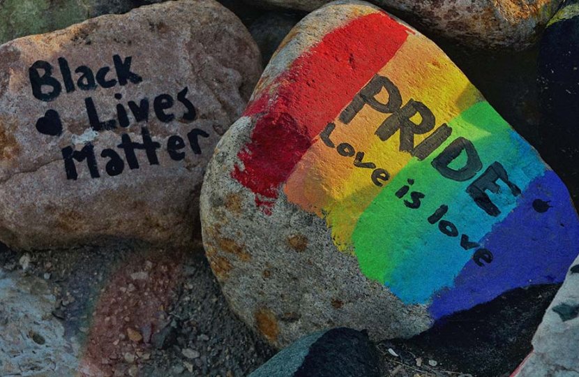 Picture of painted rocks that read "Black Lives Matter" and one with a rainbow with the words "Pride" and "Love is love"