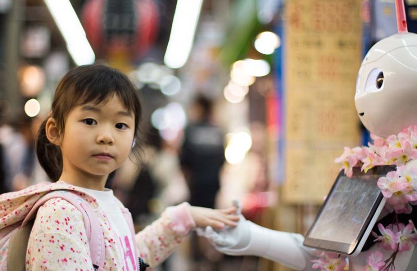 Photo of child with a robot