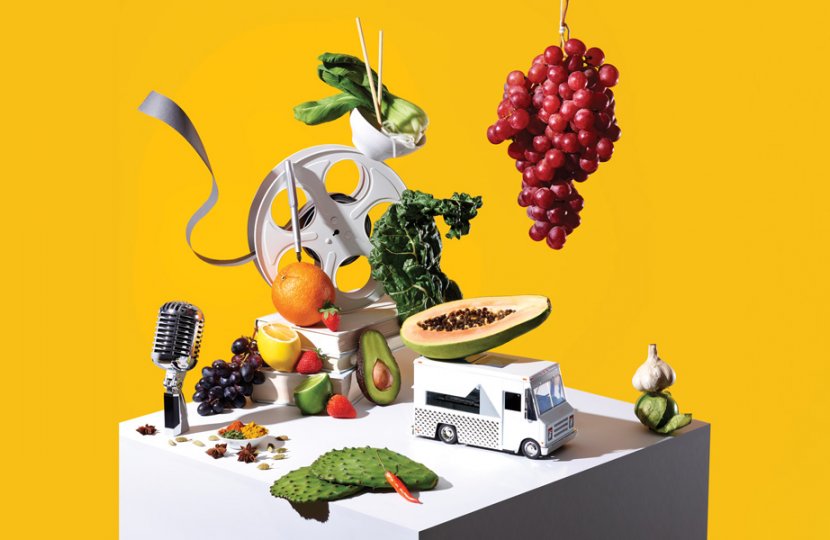 Photo of fruits and vegetable around a film roll, a vehicle, and a microphone