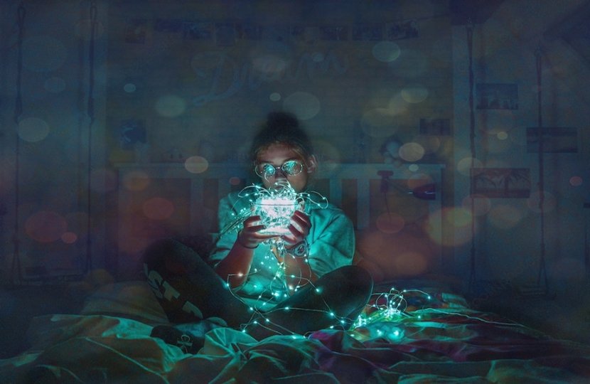 Photo of a person holding a ball of string lights