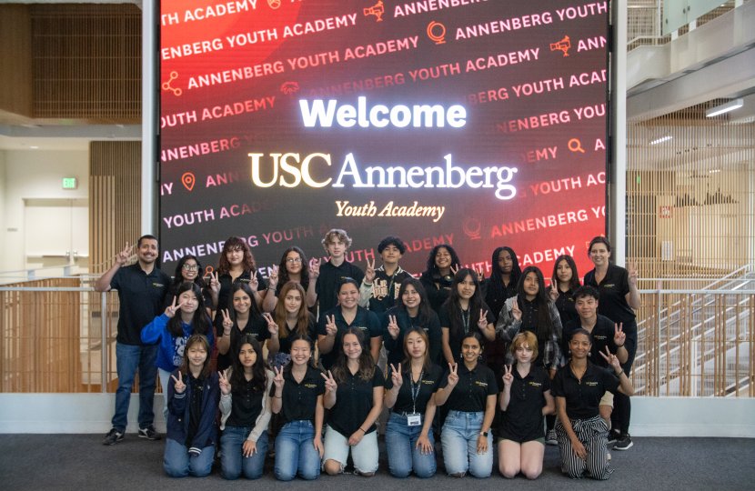 group photo of 25 high school students and two instructors wearing black t-shirts