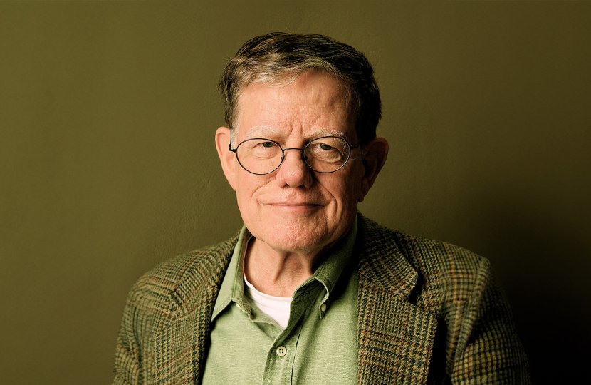 Male in green shirt and blazer wearing glasses