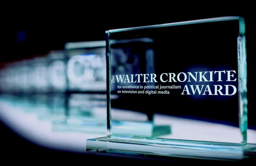 Glass awards extend back into a black background.